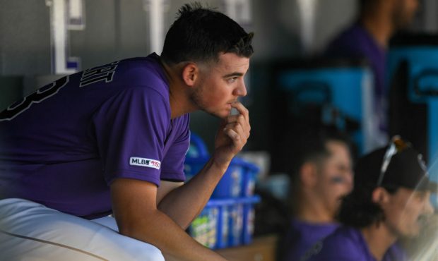 Peter Lambert #23 of the Colorado Rockies sits in the dugout between innings during a game against ...