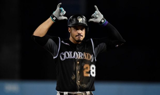Nolan Arenado #28 of the Colorado Rockies reacts after hitting a base hit off of starting pitcher H...