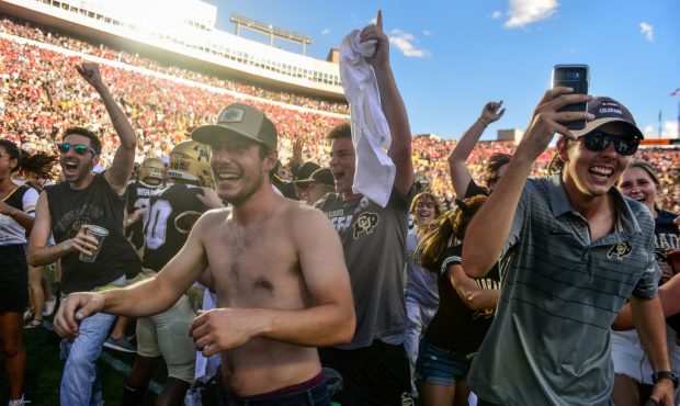 Colorado Buffaloes fans rush the field after the Colorado Buffaloes 34-31 overtime win over the Neb...