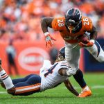 DENVER, CO - SEPTEMBER 15:  Royce Freeman #28 of the Denver Broncos is tripped up by Buster Skrine #24 of the Chicago Bears in the fourth quarter of a game at Empower Field at Mile High on September 15, 2019 in Denver, Colorado. (Photo by Dustin Bradford/Getty Images)