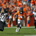 DENVER, CO - SEPTEMBER 29:  Running back Phillip Lindsay #30 of the Denver Broncos runs for a first down as cornerback Tre Herndon #37 of the Jacksonville Jaguars and defensive back Ronnie Harrison #36 of the Jacksonville Jaguars give chase during the first quarter at Empower Field at Mile High on September 29, 2019 in Denver, Colorado. (Photo by Justin Edmonds/Getty Images)