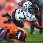 DENVER, CO - SEPTEMBER 29:  Leonard Fournette #27 of the Jacksonville Jaguars is stopped by DeVante Bausby #41 of the Denver Broncos in the fourth quarter of a game at Empower Field at Mile High on September 29, 2019 in Denver, Colorado. (Photo by Dustin Bradford/Getty Images)