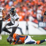 DENVER, CO - SEPTEMBER 29:  Dede Westbrook #12 of the Jacksonville Jaguars is tripped up by DeVante Bausby #41 of the Denver Broncos after a fourth quarter catch at Empower Field at Mile High on September 29, 2019 in Denver, Colorado. (Photo by Dustin Bradford/Getty Images)
