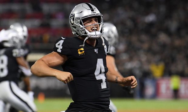 Derek Carr #4 of the Oakland Raiders celebrates after a touchdown by Josh Jacobs #28 during their N...