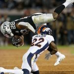 Josh Jacobs #28 of the Oakland Raiders is tackled by Kareem Jackson #22 of the Denver Broncos in the third quarter of the game at RingCentral Coliseum on September 09, 2019 in Oakland, California. (Photo by Lachlan Cunningham/Getty Images)