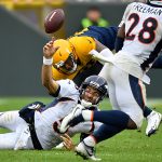 GREEN BAY, WISCONSIN - SEPTEMBER 22: Joe Flacco #5 of the Denver Broncos is sacked in the fourth quarter by Preston Smith #91 of the Green Bay Packers as he was attempting a pass to Royce Freeman #28 of the Denver Broncos at Lambeau Field on September 22, 2019 in Green Bay, Wisconsin. (Photo by Quinn Harris/Getty Images)