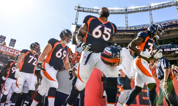 DENVER, CO - OCTOBER 13: Denver Broncos players including Ronald Leary #65 run onto the field to wa...