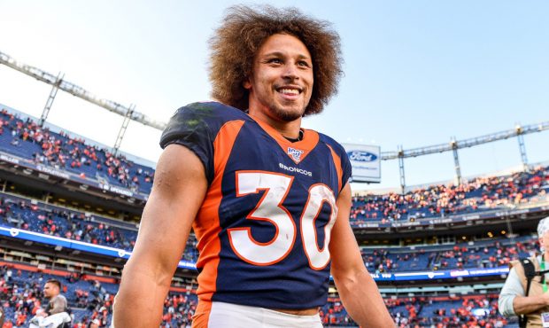 DENVER, CO - OCTOBER 13: Phillip Lindsay #30 of the Denver Broncos smiles as he walks on the field ...