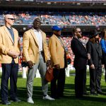 DENVER, CO - OCTOBER 13:  From left, John Elway, Gary Zimmerman, Shannon Sharpe, Floyd Lyttle, Patrick Bowlen Jr., John Bowlen, Beth Bowlen, Annabel Bowlen and Brittany Bowlen stand on the field during a halftime ceremony to honor the late owner of the Denver Broncos Pat Bowlen and former cornerback Champ Bailey, both of whom were recently inducted into the Pro Football Hall of Fame during a game against the Tennessee Titans at Empower Field at Mile High on October 13, 2019 in Denver, Colorado. (Photo by Justin Edmonds/Getty Images)