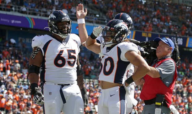 Phillip Lindsay #30 of the Denver Broncos celebrates a touchdown with Ronald Leary #65 in the first...