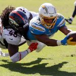 Austin Ekeler #30 of the Los Angeles Chargers is tackled by A.J. Johnson #45 of the Denver Broncos during the first half of a game at Dignity Health Sports Park on October 06, 2019 in Carson, California. (Photo by Sean M. Haffey/Getty Images)