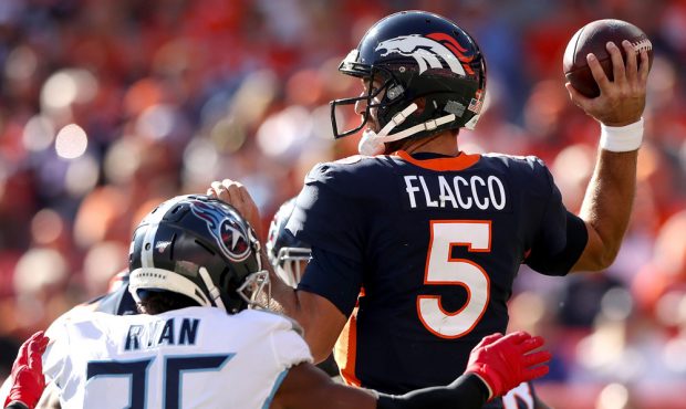 DENVER, COLORADO - OCTOBER 13: Quarterback Joe Flacco #5 of the Denver Broncos throws under pressur...