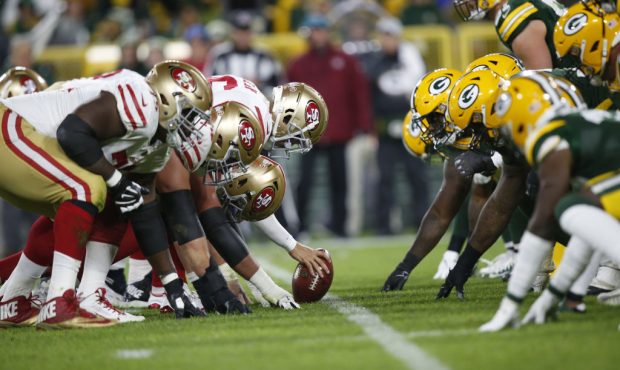 GREEN BAY, WI - OCTOBER 15: The San Francisco 49ers and Green Bay Packers line up for the snap duri...