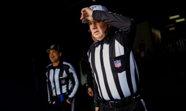DENVER, CO - NOVEMBER 3: Referee Bill Vinovich #52 adjusts his hat on the way to the field before a...