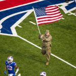 ORCHARD PARK, NY - NOVEMBER 24:  A member of the US Army runs with Buffalo Bills players before the game against the Denver Broncos at New Era Field on November 24, 2019 in Orchard Park, New York. (Photo by Brett Carlsen/Getty Images)