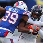 ORCHARD PARK, NY - NOVEMBER 24:  Levi Wallace #39 of the Buffalo Bills tries to tackle Royce Freeman #28 of the Denver Broncos as he runs the ball during the second half at New Era Field on November 24, 2019 in Orchard Park, New York.  Buffalo beats Denver 20 to 3. (Photo by Timothy T Ludwig/Getty Images)