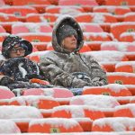 KANSAS CITY, MO - DECEMBER 15:  A few fans sit in the snow covered stands before a game between the Kansas City Chiefs and Denver Broncos at Arrowhead Stadium on December 15, 2019 in Kansas City, Missouri. (Photo by Peter Aiken/Getty Images)