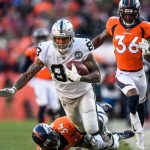 DENVER, CO - DECEMBER 29:  Darren Waller #83 of the Oakland Raiders is tackled by Will Parks #34 of the Denver Broncos after a 79-yard reception against the Denver Broncos in the first quarter of a game at Empower Field at Mile High on December 29, 2019 in Denver, Colorado.  (Photo by Dustin Bradford/Getty Images)