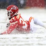 KANSAS CITY, MISSOURI - DECEMBER 15: Darwin Thompson #34 of the Kansas City Chiefs slides in the snow during a play against the Denver Broncos in the game at Arrowhead Stadium on December 15, 2019 in Kansas City, Missouri. (Photo by Jamie Squire/Getty Images)