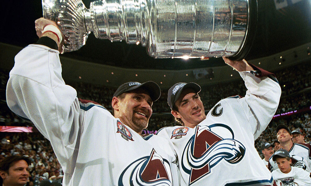 DENVER, COLORADO - JUNE 9: Ray Bourque #77 of the Colorado Avalanche lifts the cup with Joe Sakic #19 after the Colorado Avalanche defeated the New Jersey Devils 3-1 in game seven of the NHL Stanley Cup Finals at Pepsi Center in Denver, Colorado. The Avalanche take the series 4-3. (Photo by B Bennett/Getty Images)