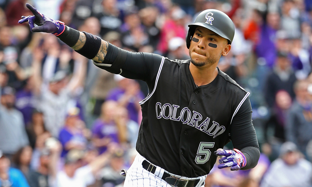 DENVER, CO - APRIL 10: Carlos Gonzalez #5 of the Colorado Rockies celebrates his solo home run off of Brandon Maurer #37 of the San Diego Padres to take a 6-3 lead in the eighth inning on April 10, 2016 in Denver, Colorado. The Rockies defeated the Padres 6-3. (Photo by Doug Pensinger/Getty Images)