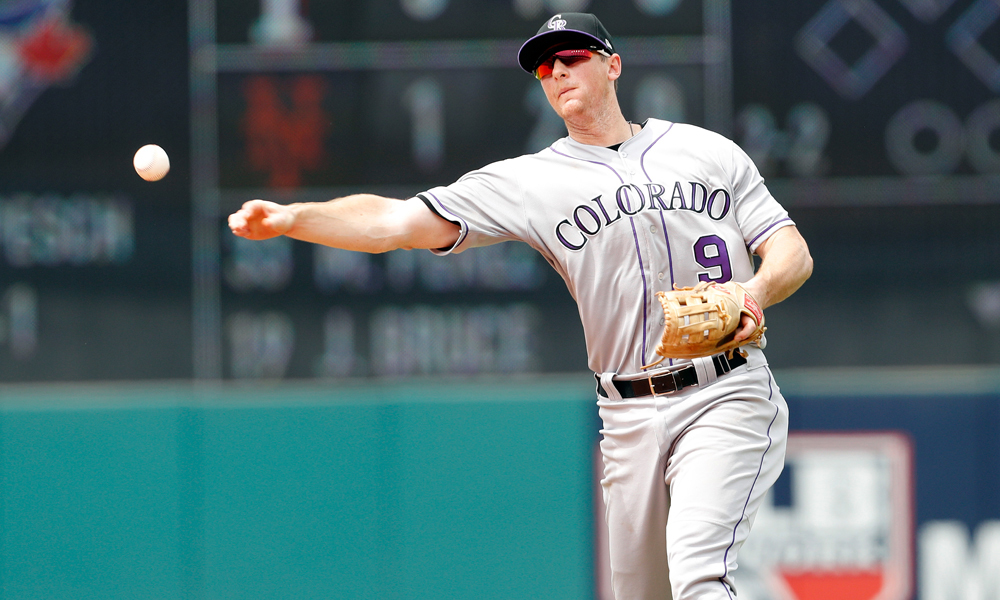 CLEVELAND, OH - AUGUST 09: DJ LeMahieu #9 of the Colorado Rockies throws to first base against the Cleveland Indians in the eighth inning at Progressive Field on August 9, 2017 in Cleveland, Ohio. The Rockies defeated the Indians 3-2 in 12 innings. (Photo by David Maxwell/Getty Images)