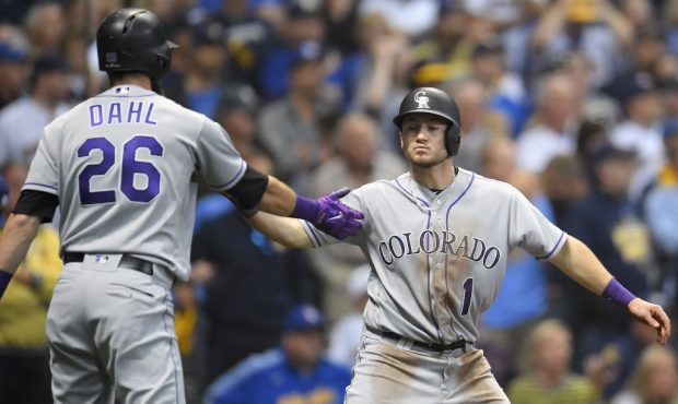 Garrett Hampson #1 of the Colorado Rockies celebrates scoring with teammate David Dahl #26 on a sac...