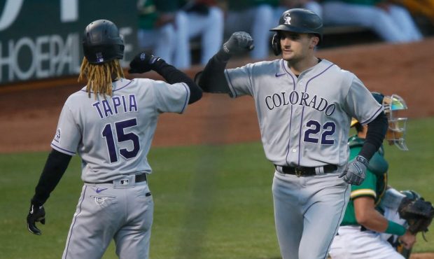 Sam Hilliard #22 of the Colorado Rockies celebrates with Raimel Tapia #15 after hitting a two-run h...