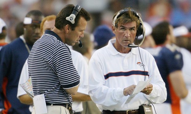 Head coach Mike Shanahan and offensive coordinator Gary Kubiak of the Denver Broncos watch the cloc...