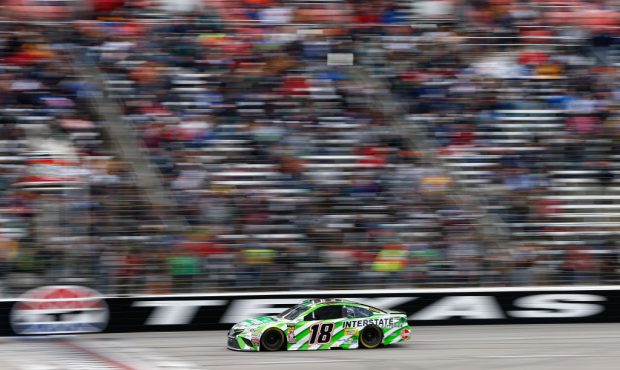 FORT WORTH, TX - APRIL 08: Kyle Busch, driver of the #18 Interstate Batteries Toyota, takes the che...
