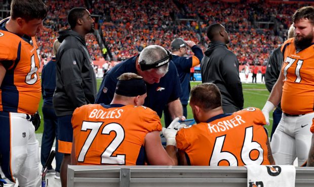 Denver Broncos offensive line coach Mike Munchak working with offensive tackle Garett Bolles #72 an...