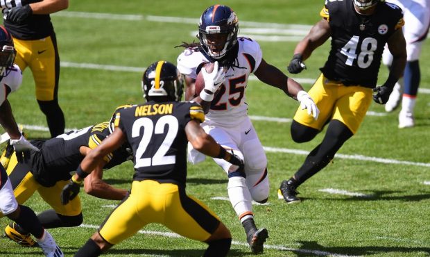 Melvin Gordon #25 of the Denver Broncos carries the ball in front of Steven Nelson #22 of the Pitts...