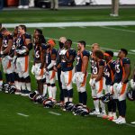 Denver Broncos players stand during a tribute to social justice before a game against the Tennessee Titans at Empower Field at Mile High on September 14, 2020 in Denver, Colorado. (Photo by Dustin Bradford/Getty Images)