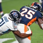 Melvin Gordon III #25 of the Denver Broncos fumbles the ball as he is hit by Kevin Byard #31 of the Tennessee Titans on a second quarter pass play at Empower Field at Mile High on September 14, 2020 in Denver, Colorado. (Photo by Dustin Bradford/Getty Images)