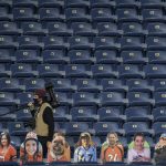 Professional photographer Dustin Bradford walks the stands behind cutouts of fans during the first quarter between the Tennessee Titans and the Denver Broncos  on Monday, September 14, 2020. (Photo by AAron Ontiveroz/MediaNews Group/The Denver Post via Getty Images)