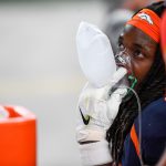 Melvin Gordon III #25 of the Denver Broncos takes oxygen while on the sideline during a game against the Tennessee Titans at Empower Field at Mile High on September 14, 2020 in Denver, Colorado. (Photo by Dustin Bradford/Getty Images)