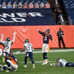 Drew Lock #3 of the Denver Broncos throws an unsuccessful last-second hail mary pass attempt under coverage by Tennessee Titans defenders at Empower Field at Mile High on September 14, 2020 in Denver, Colorado. (Photo by Dustin Bradford/Getty Images)