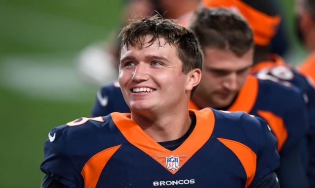 DENVER, CO - SEPTEMBER 14:  Drew Lock #3 of the Denver Broncos smiles in the bench area during a ga...
