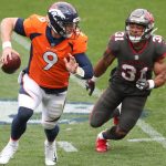 Quarterback Jeff Driskel #9 of the Denver Broncos eludes a tackle by strong safety Antoine Winfield Jr. #31 of the Tampa Bay Buccaneers during the first half at Empower Field At Mile High on September 27, 2020 in Denver, Colorado. (Photo by Matthew Stockman/Getty Images)