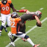 Tight end Rob Gronkowski #87 of the Tampa Bay Buccaneers is tackled by strong safety Kareem Jackson #22 of the Denver Broncos during the first half at Empower Field At Mile High on September 27, 2020 in Denver, Colorado. (Photo by Matthew Stockman/Getty Images)
