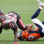 Running back Ronald Jones #27 of the Tampa Bay Buccaneers is tackled by cornerback Bryce Callahan #29 of the Denver Broncos during the second half at Empower Field At Mile High on September 27, 2020 in Denver, Colorado. (Photo by Matthew Stockman/Getty Images)