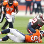 Quarterback Tom Brady #12 of the Tampa Bay Buccaneers is sacked by outside linebacker Bradley Chubb #55 of the Denver Broncos during the second half at Empower Field At Mile High on September 27, 2020 in Denver, Colorado. (Photo by Matthew Stockman/Getty Images)