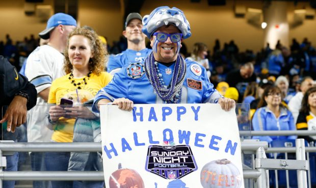 A Detroit Lions fan holds a sign wishing "Sunday Night Football" a Happy Halloween during first hal...