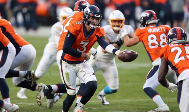 DENVER, COLORADO - NOVEMBER 01: Quarterback Drew Lock #3 of the Denver Broncos hands the ball off t...