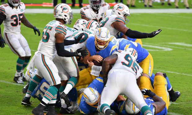 Justin Herbert #10 of the Los Angeles Chargers dives for a rushing touchdown against the Miami Dolp...
