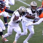 DENVER, COLORADO - NOVEMBER 29: Alvin Kamara #41 of the New Orleans Saints rushes against A.J. Bouye #21 and Jeremiah Attaochu #97 of the Denver Broncos during the first quarter at Empower Field At Mile High on November 29, 2020 in Denver, Colorado. (Photo by Matthew Stockman/Getty Images)