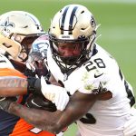 DENVER, COLORADO - NOVEMBER 29: Latavius Murray #28 of the New Orleans Saints rushes against Dre'Mont Jones #93 of the Denver Broncos during the second quarter of a game at Empower Field At Mile High on November 29, 2020 in Denver, Colorado. (Photo by Matthew Stockman/Getty Images)
