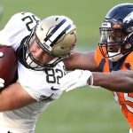 DENVER, COLORADO - NOVEMBER 29: Adam Trautman #82 of the New Orleans Saints rushes under pressure from Dre'Mont Jones #93 of the Denver Broncos during the second quarter of a game at Empower Field At Mile High on November 29, 2020 in Denver, Colorado. (Photo by Matthew Stockman/Getty Images)