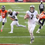 DENVER, COLORADO - NOVEMBER 29: Taysom Hill #7 of the New Orleans Saints rushes for a two yard touchdown during the second quarter of a game against the Denver Broncos at Empower Field At Mile High on November 29, 2020 in Denver, Colorado. (Photo by Matthew Stockman/Getty Images)