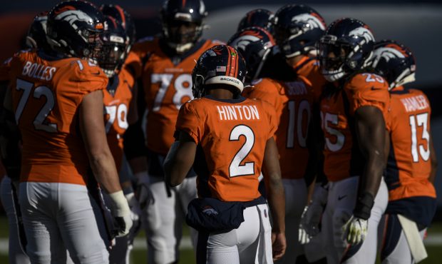 DENVER, CO - NOVEMBER 29: Kendall Hinton (2) of the Denver Broncos huddles the offense against the ...
